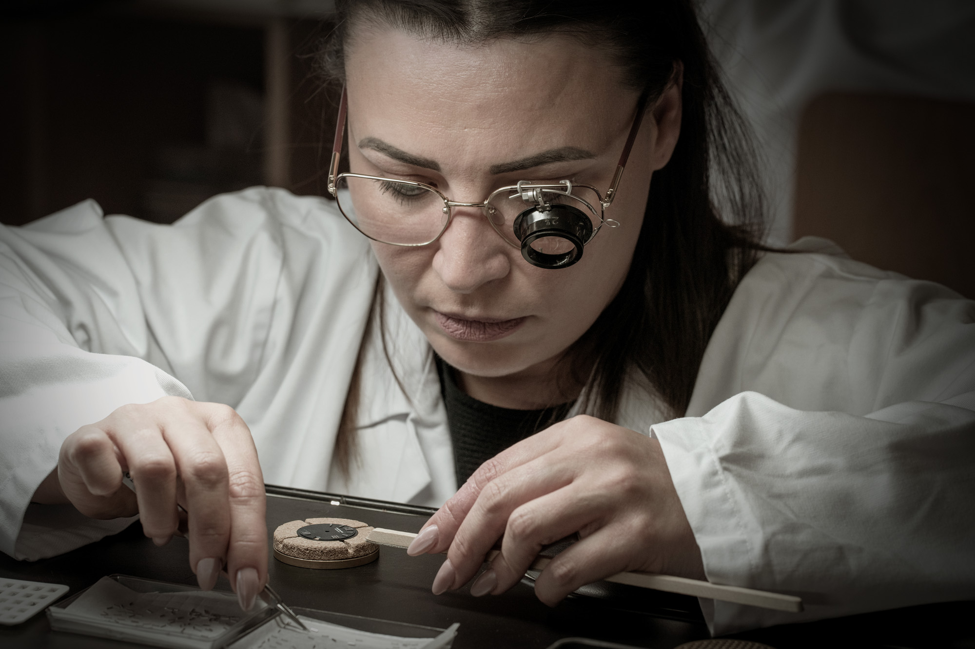 Artisan crafting a watch dial
